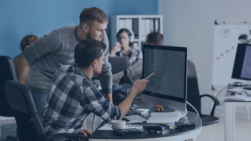 Deux hommes jeunes qui regardent un écran d'ordinateur