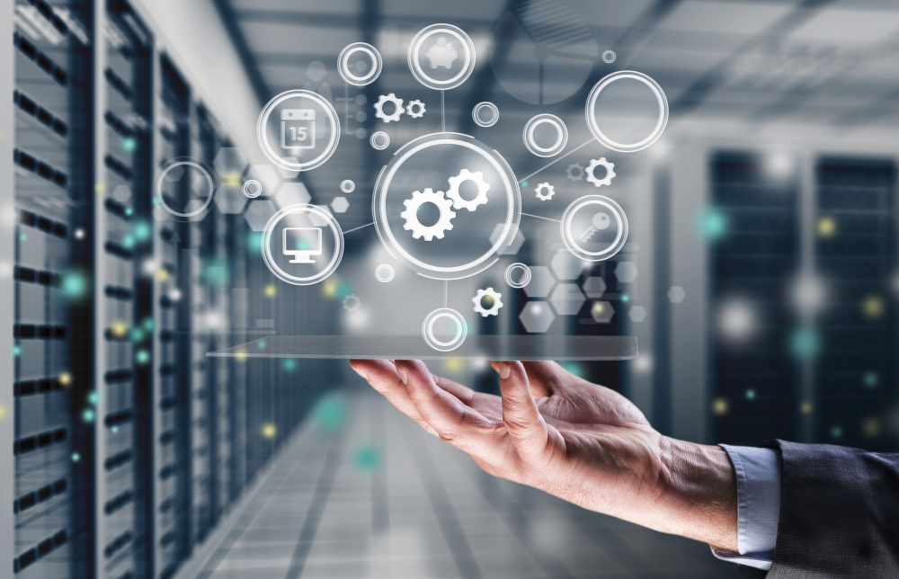 Un panel de services informatiques représentés par des icones en surimpression d'une salle serveur